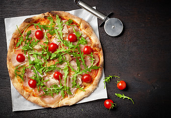 Image showing freshly baked pizza on dark wooden table