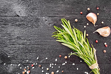 Image showing Frame of rosemary and garlic on black board top