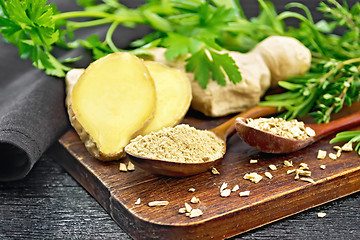 Image showing Ginger ground and flakes in spoons on black board