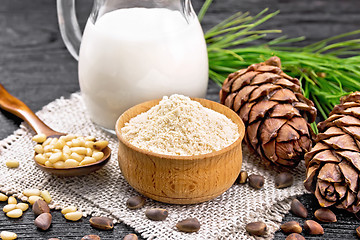 Image showing Flour cedar in bowl with nuts on board