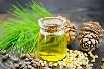 Image showing Oil cedar in glass jar on dark board