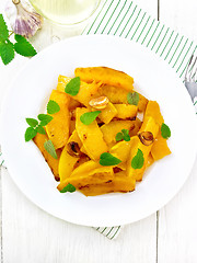 Image showing Pumpkin with garlic in plate on light board top