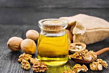 Image showing Oil walnut in jar on board