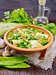 Image showing Salad with squash and sorrel in plate on board