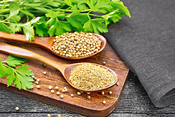 Image showing Coriander ground and seeds in two spoons on wooden board