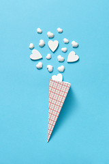 Image showing Valentine\'s card with paper cone of white plaster hearts.