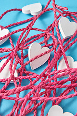 Image showing Close-up background from red rope and white hearts.