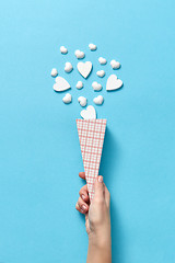 Image showing Paper cone with small hearts in woman\'s hand.