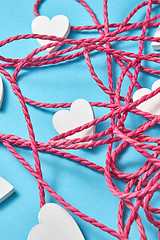 Image showing Festive background with rope and white hearts.