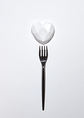 Image showing Black plaster fork with gypsum white heart .