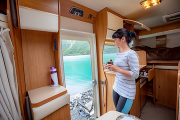 Image showing Woman in the interior of a camper RV motorhome with a cup of cof