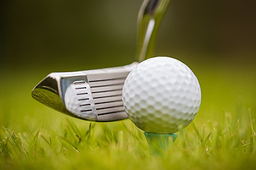 Image showing Golf ball on tee in front of driver