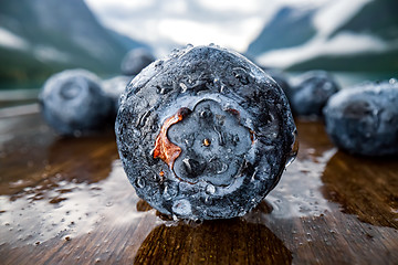 Image showing Blueberry antioxidants on a wooden table on a background of Norw