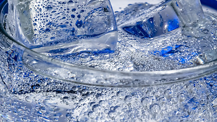 Image showing Glass of water with ice on a dark blue background