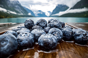 Image showing Blueberry antioxidants on a wooden table on a background of Norw