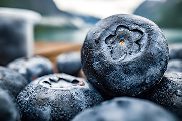 Image showing Blueberry antioxidants on a wooden table on a background of Norw