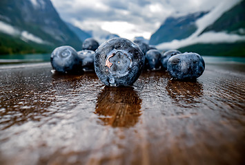 Image showing Blueberry antioxidants on a wooden table on a background of Norw