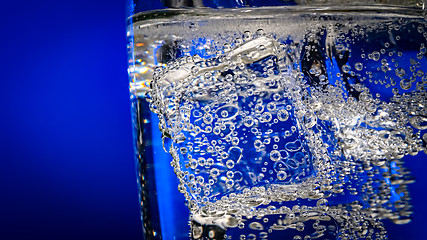 Image showing Glass of water with ice on a dark blue background