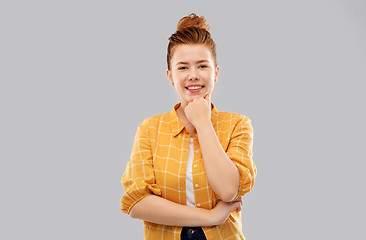 Image showing smiling red haired teenage girl in checkered shirt