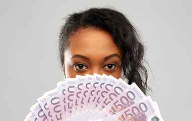 Image showing african american woman hiding face behind money