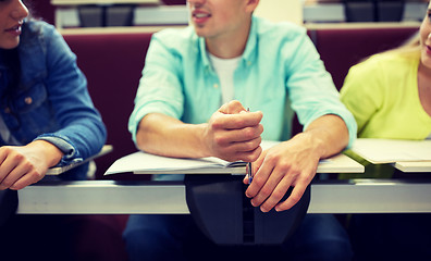 Image showing group of students with notebooks in lecture hall