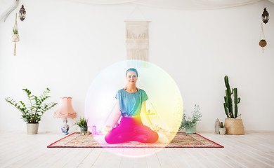 Image showing woman meditating in lotus pose at yoga studio