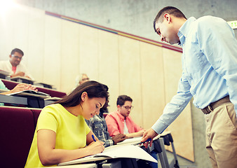 Image showing group of students and teacher with notebook