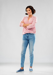 Image showing young woman in shirt and jeans with crossed arms