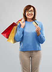 Image showing senior woman with shopping bags and credit card