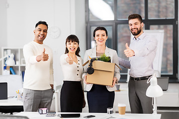 Image showing new office worker and colleagues showing thumbs up