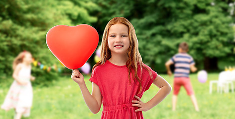 Image showing smiling red haired girl with heart shaped balloon