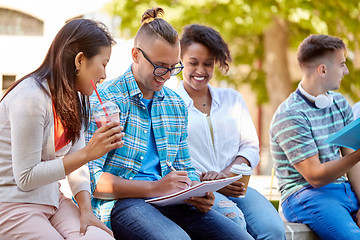 Image showing group of happy students with notebook and drinks