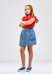 Image showing displeased girl with crossed arms over grey