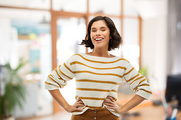 Image showing smiling woman in pullover with hands on hips