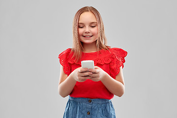 Image showing beautiful smiling girl using smartphone