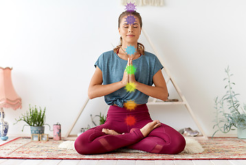 Image showing woman meditating in lotus pose at yoga studio