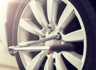 Image showing screwdriver and car wheel tire