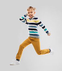 Image showing happy little boy jumping and having fun