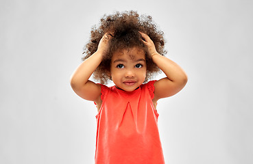 Image showing overwhelmed african american girl holding to head