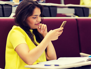 Image showing student girl with smartphone on lecture