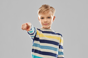 Image showing smiling boy in striped pullover pointing finger