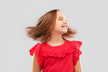 Image showing happy girl in red shirt with waving hair