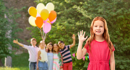 Image showing red haired girl waving hand at birthday party