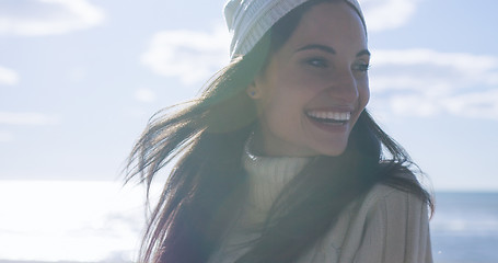 Image showing Girl In Autumn Clothes Smiling on beach