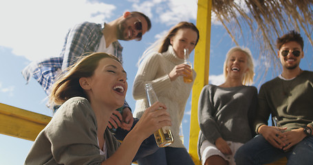 Image showing Group of friends having fun on autumn day at beach