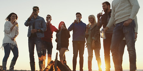 Image showing Friends having fun at beach on autumn day