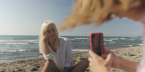 Image showing Two girl friends having fun photographing each other on vecation