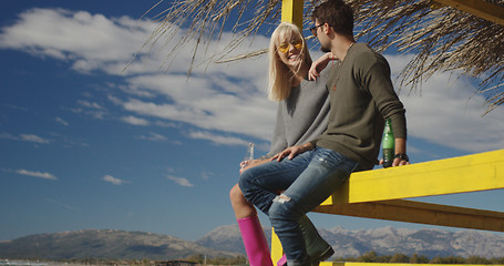 Image showing Couple drinking beer together at the beach