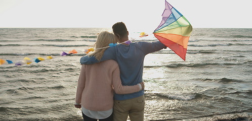 Image showing Happy couple having fun with kite on beach