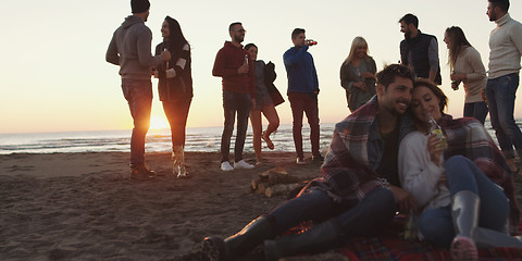 Image showing Friends having fun at beach on autumn day